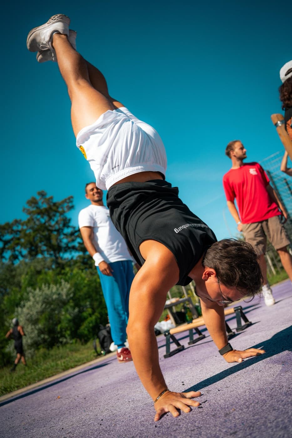 Athlete doing a handstand at a calisthenics park